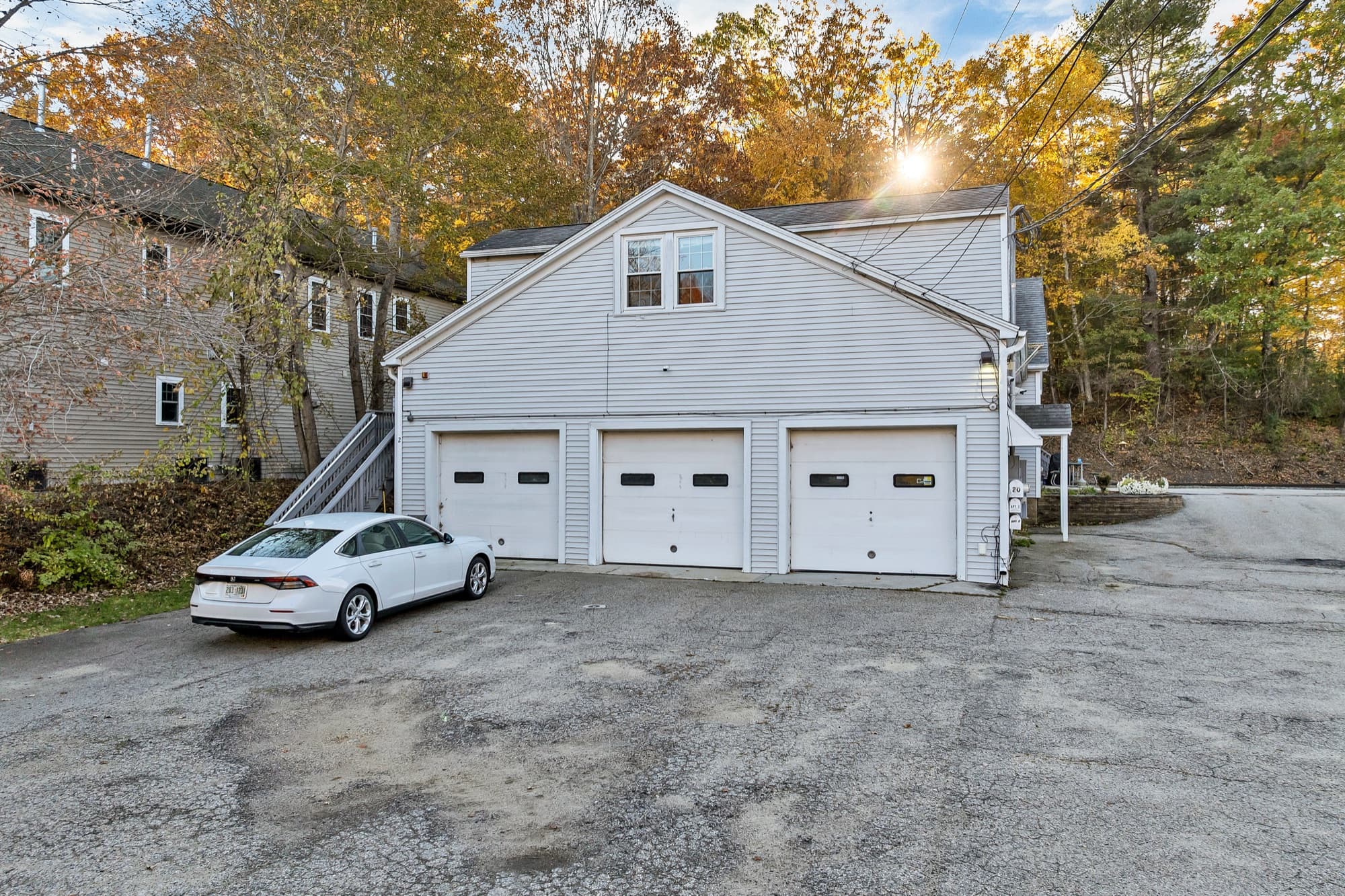 The 3 garage doors from the lot, with a window in the gable above