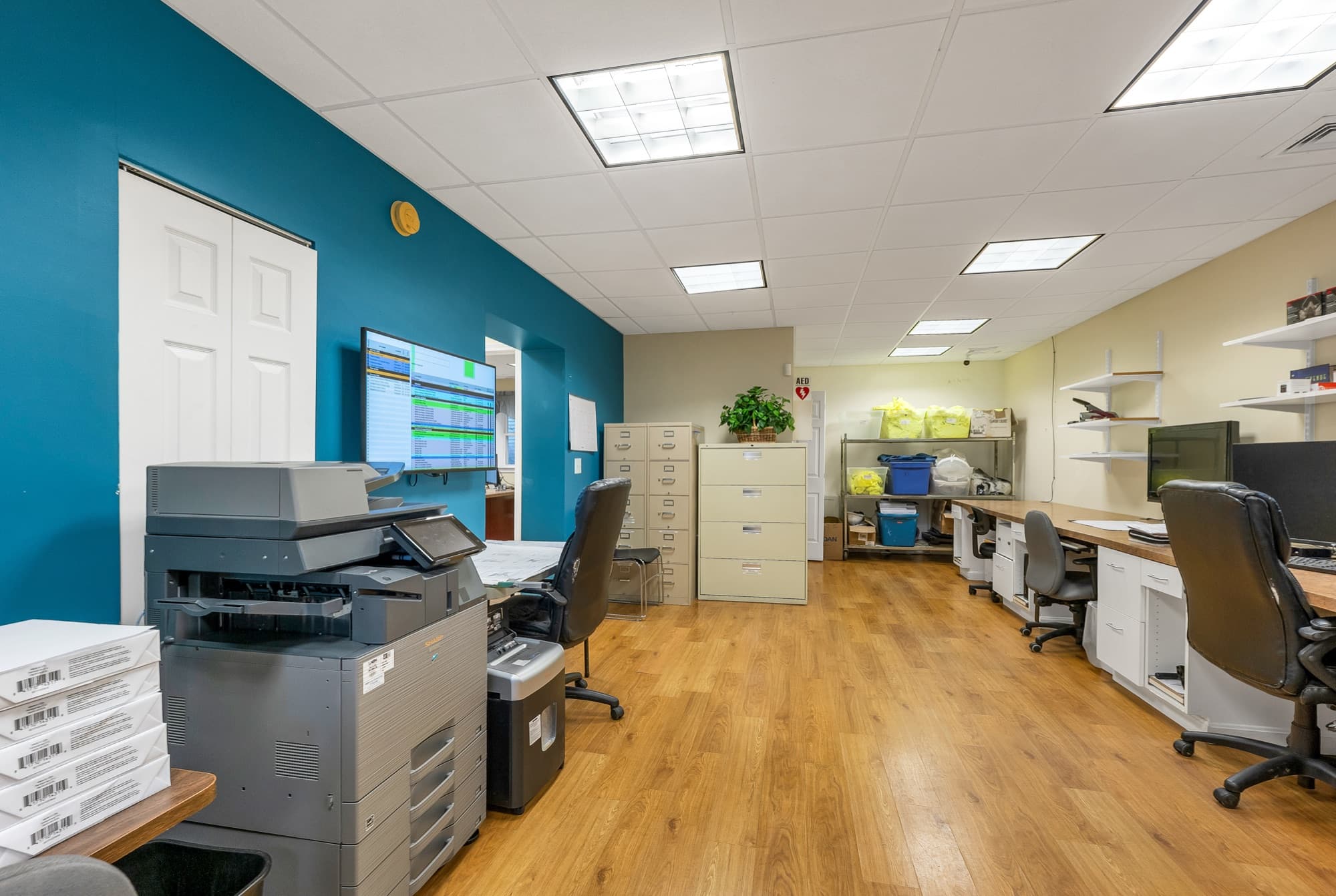 The open office from the copier end, with file cabinets and shelving